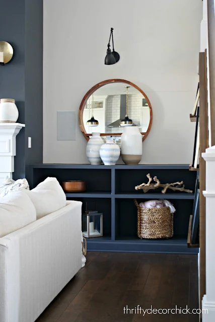 white, light blue and cream large vases on bookcase