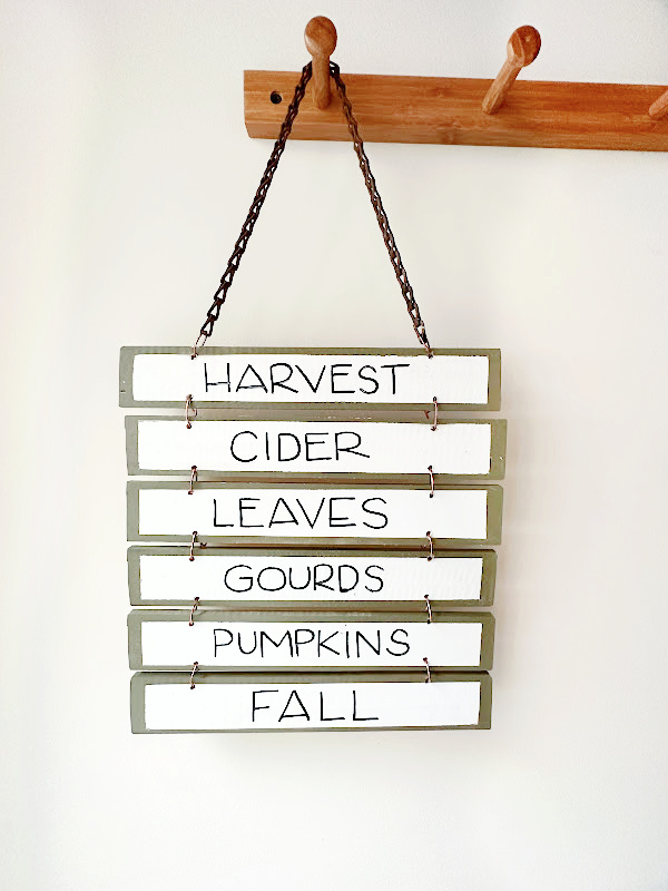 harvest sign hanging from pegs