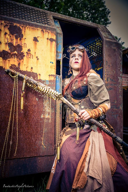 Woman wearing Steampunk clothing. Wearing watch parts and wind up keys as a headpiece.