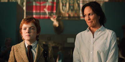 Netflix's movie "Rim of the World" stars Jack Gore and Annabeth Gish stand and stare at summer camp.