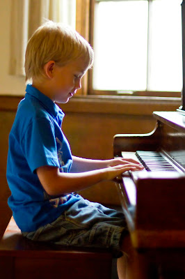 Maxton playing the piano at the piano recital