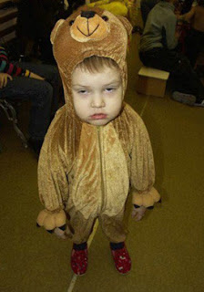 cute kid in a bear suit