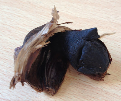 close up black garlic clove