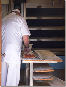 Pizza being freshly made at a pizzeria in Rome
