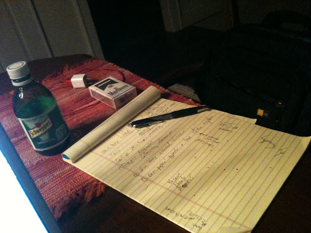 Cigarettes, ginger ale, boston baked bean crumbs, a pen, yellow lined paper.