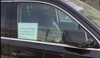Does placing a 'no valuables inside' sign in a car window deter break-ins?