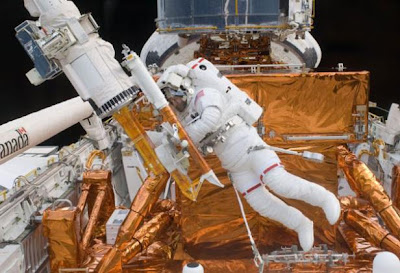 Mike Massimino repairing the Hubble Space Telescope