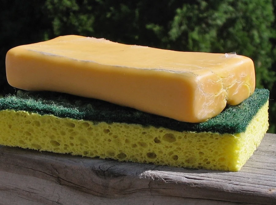 A bar of soap sitting on a sponge