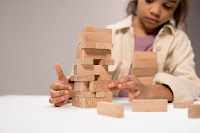 A little girl adept at building blocks