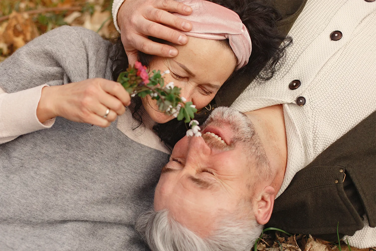 happy senior couple hugging in the forest