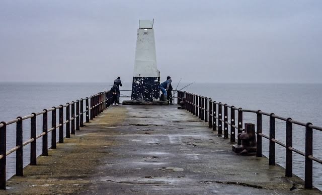 Photo of fishermen on Maryport pier in misty conditions