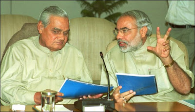 Vajpayee and Narendra Modi discussing some issues without looking at camera