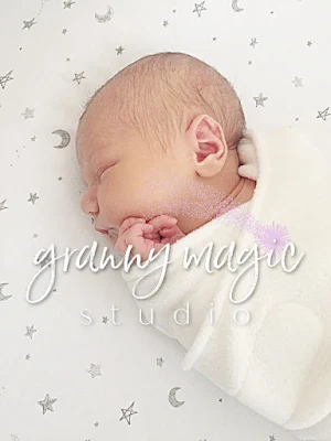 Darling newborn wrapped in receiving blanket and sleeping.