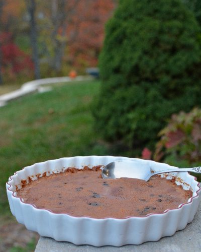 Apple Cider Indian Pudding ♥ KitchenParade.com, a colonial New England dessert made with cornmeal and currants, served warm, decidedly delicious.