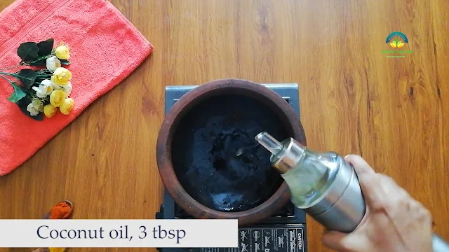 A wide-mouthed earthen pot with coconut oil being poured into it, set against a backdrop of a stovetop flame.