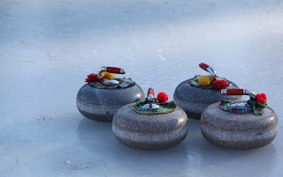 image four curling rocks on ice