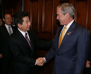 President George W. Bush welcomes President Roh Moo-hyun of the Republic of Korea, to a meeting Friday, Sept. 7, 2007, at the InterContinental hotel in Sydney. President Bush told his counterpart, '...When we have worked together, we have shown that it's possible to achieve the peace on the Korean Peninsula that the people long for. So thank you, sir.' White House photo by Eric Draper