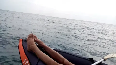 Top of a boat at sea with feet