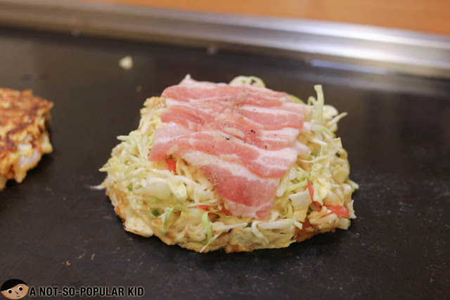 Halfway through cooking the Hamburg Cheese Steak of Dohtonbori