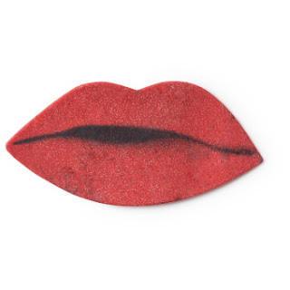 A bright red lip shaped wash card thats on a white background. 