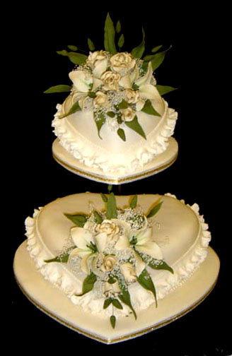 Ivory heart shaped wedding cake with roses White heart shaped wedding cake
