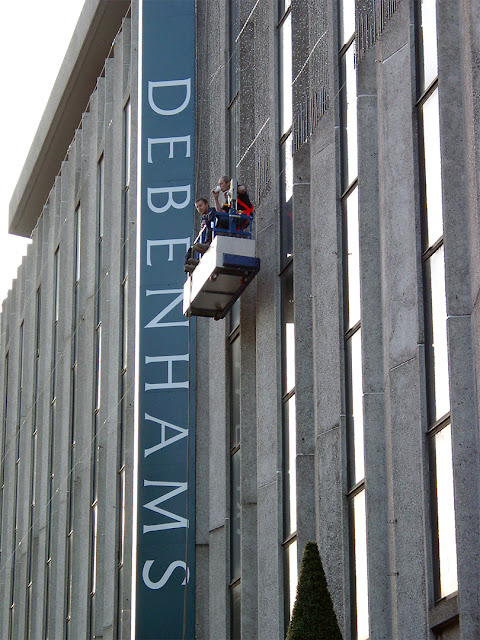 Cleaning windows at Debenhams, Oxford Street, London