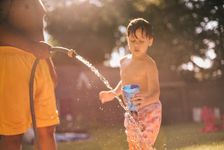 Kids playing with a hose | Whole house water filter system