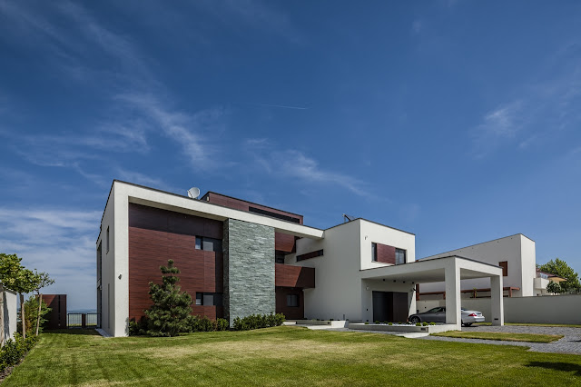 Modern home with large lawn in front of it