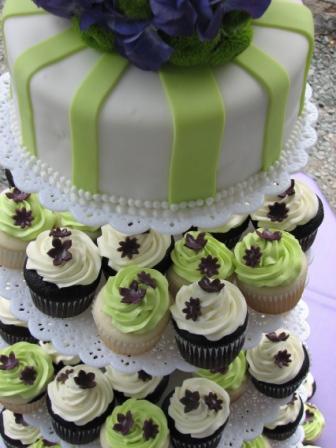 Chocolate wedding cupcakes dressed in cream icing and green topping placed 