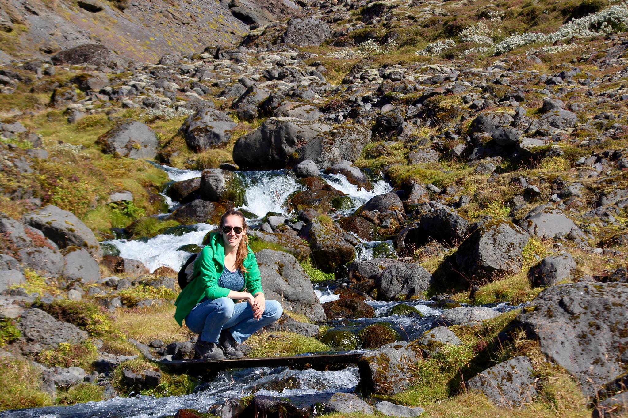 Kathi sitting in front of water running down from the Hvannadalshnúkur peak