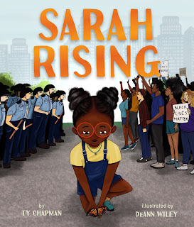 A young Black girl is kneeling down to pick up a Monarch. There is a group of police over her shoulder on the left and a group of community members with signs and raised hands on the right. The title Sarah Rising is at the top of the book cover.