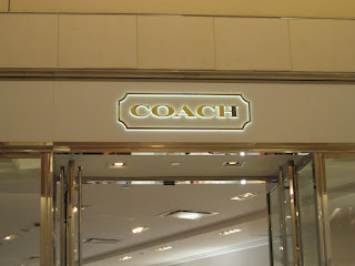 The Coach logo over the Coach store.