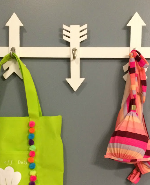 I created this Wooden Arrow Wall Hooks project out of scrap wood to hold swimsuits and beach bags.