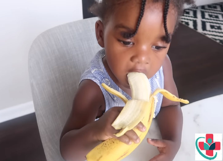 Kid eating a banana