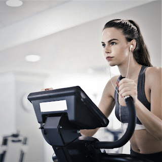 young woman on fitness machine