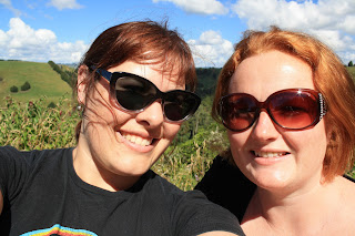 Selfie of me and Jenn. We're grinning and wearing big, dark sunglasses.