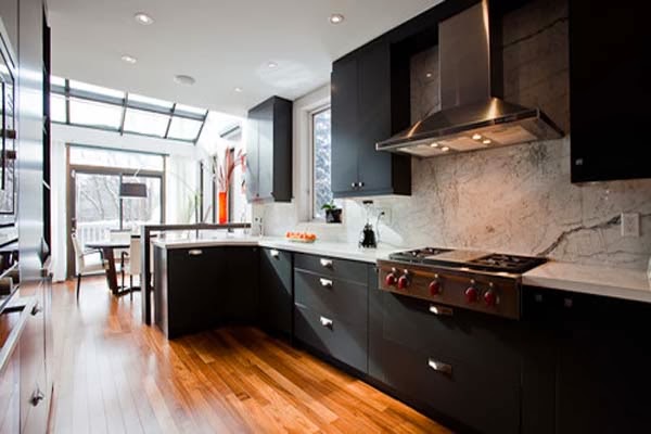 http://www.hivenn.com/wp-content/uploads/2013/07/Spacious-Modern-Style-Black-Kitchen-Cabinets-Fireplace-Wooden-Flooring.jpg