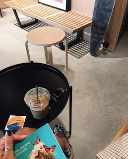 Coffee shop table with book and iced coffee