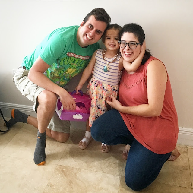 Family of three smiling for a photo on Thanksgiving Day