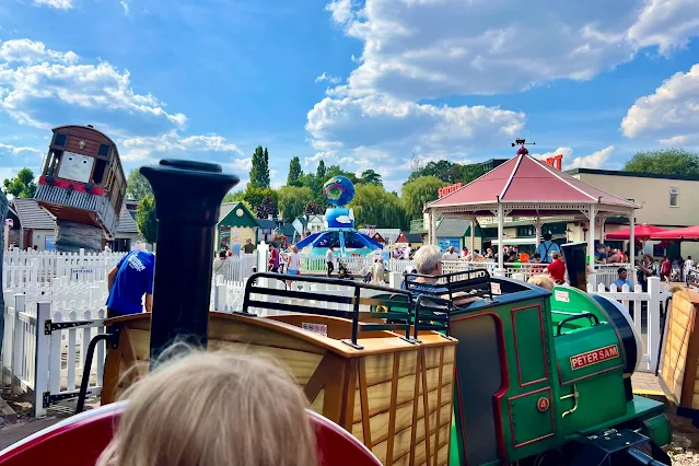 A photo taken on a circular train ride at Thomas Land with a view across to other rides