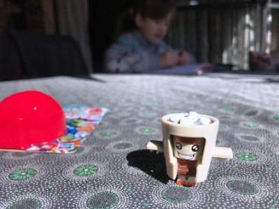 Transformer BotBot Cocoa Crazy on table with girl in background