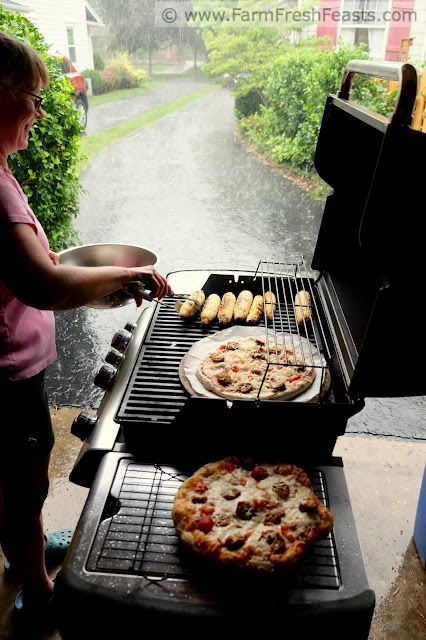 grilling pizza in the garage while it rains outside