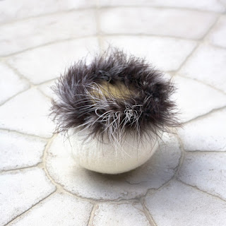 Feather-trimmed felted vessel by Kim Buchheit