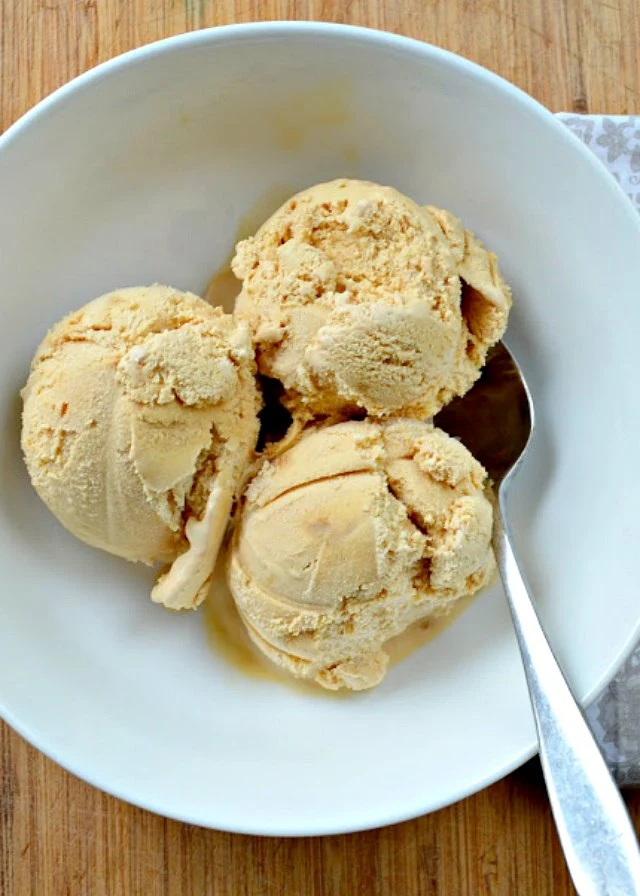 3 scoops Caramel Ice Cream with Caramel Swirl in a white bowl.