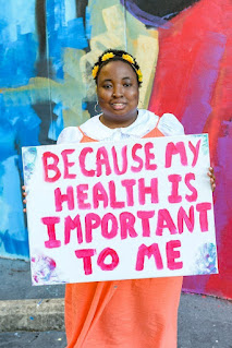 Child holding a sign that reads Because my health is important to me photo