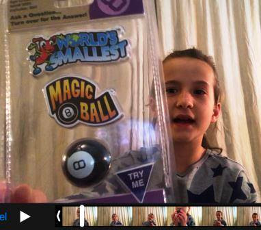 Girl with World's Smallest Magic 8 Ball in her hand