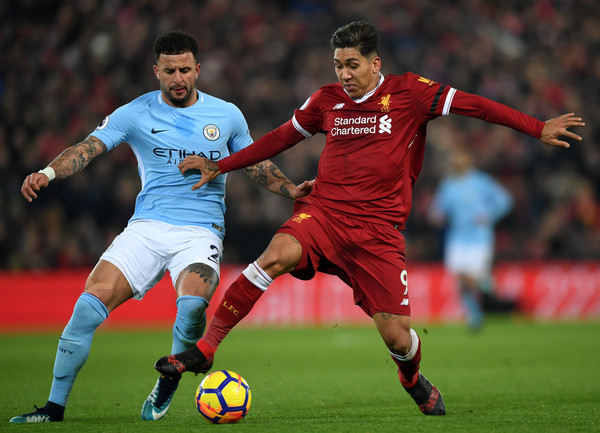 Kyle Walker of Manchester City and Roberto Firmino of Liverpool battles for possesion during the Premier League match between Liverpool and Manchester City at Anfield on January 14, 2018 in Liverpool, England.