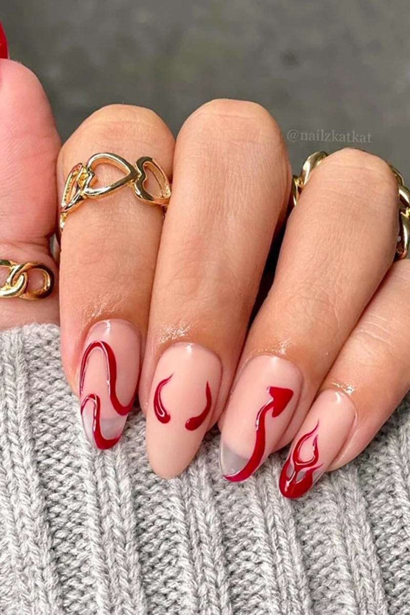 close-up of woman hand with a very cute and minimal halloween nail design with el diablo