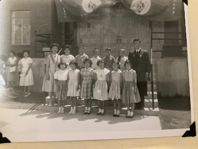 A black and white photo of the children gathered