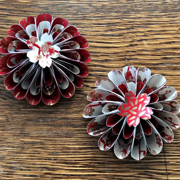 two flower-like tree ornaments made from Asian patterned papers